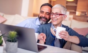 Couple smiles at computer